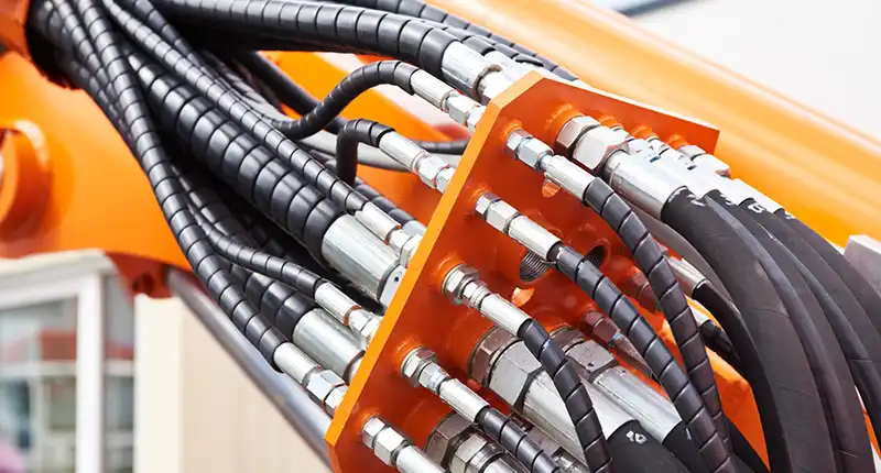 Technician installing compatible hydraulic hose fittings