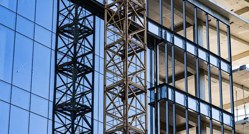A time-lapse style composite image showing the evolution of a famous Dubai building from steel frame to completion. Illustrates the "boom."